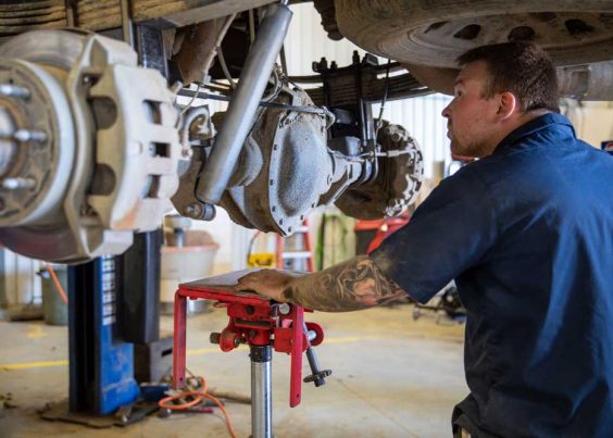 MegMar-Mechanical-Repair Mechanic Inspecting Axle